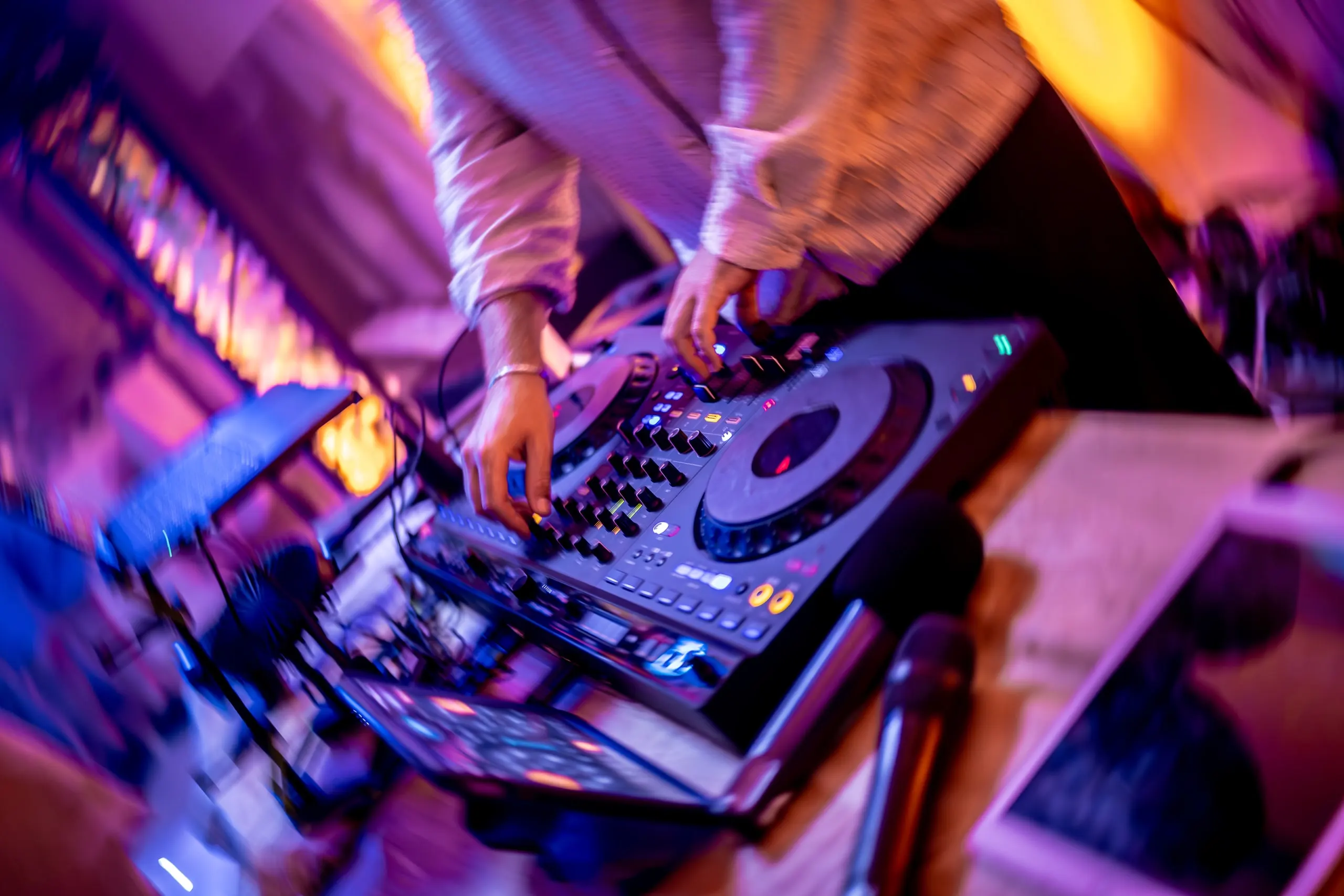 Club decks under magenta and amber lighting
