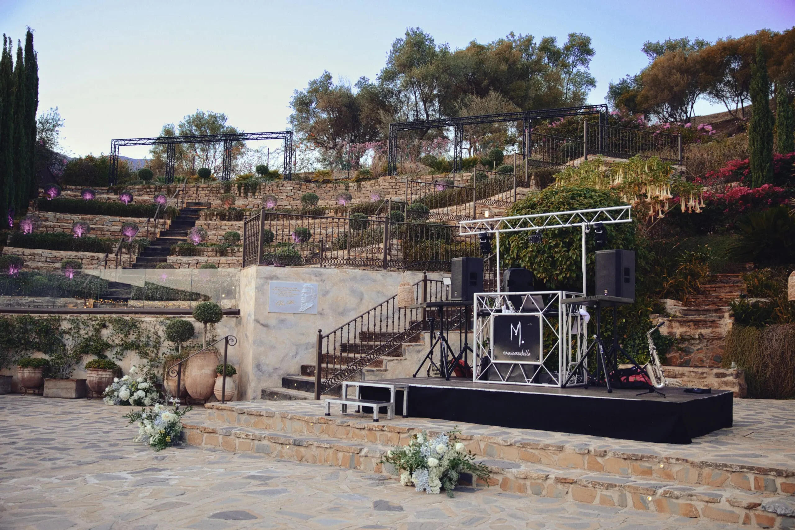 Staging, lighting truss and speakers set up on a villa terrace before an event